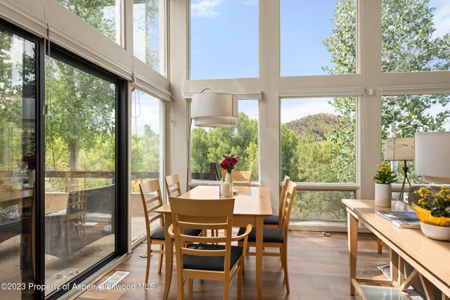 a view of a dining room with furniture window and wooden floor