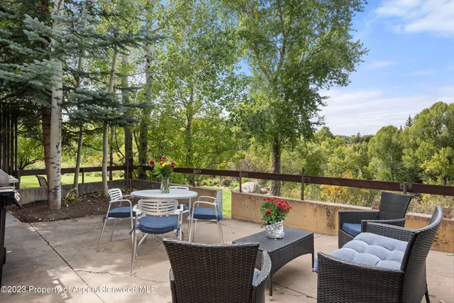 a view of a roof deck with furniture