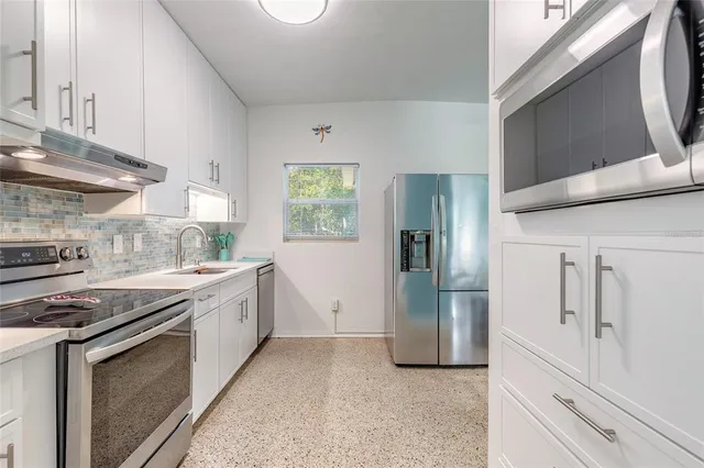 a kitchen with a sink stove and refrigerator