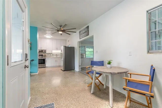 a view of kitchen with furniture and a refrigerator