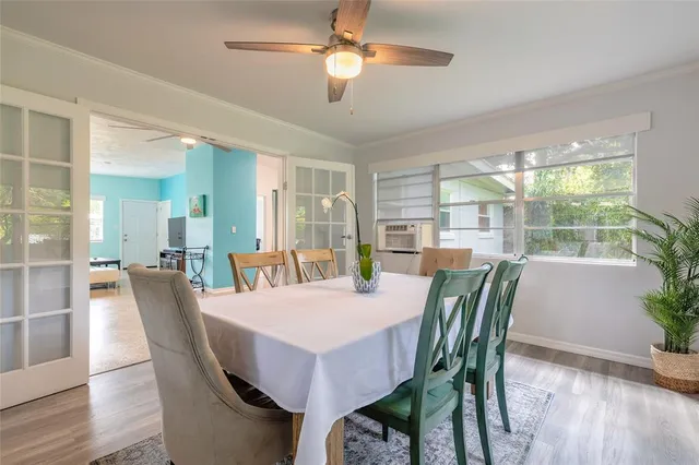 a view of a dining room with furniture window and wooden floor