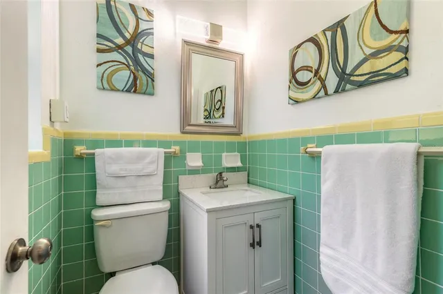 a bathroom with a sink toilet and mirror