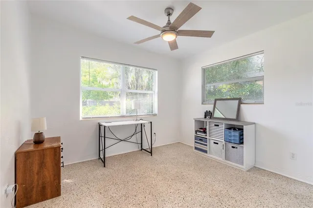 a livingroom with a window and a flat screen tv