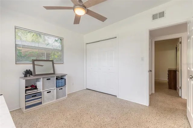 a view of workspace with cabinets and window