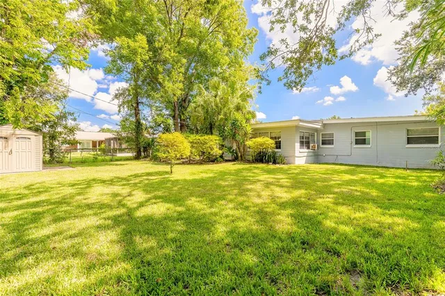 a house view with swimming pool in front of it