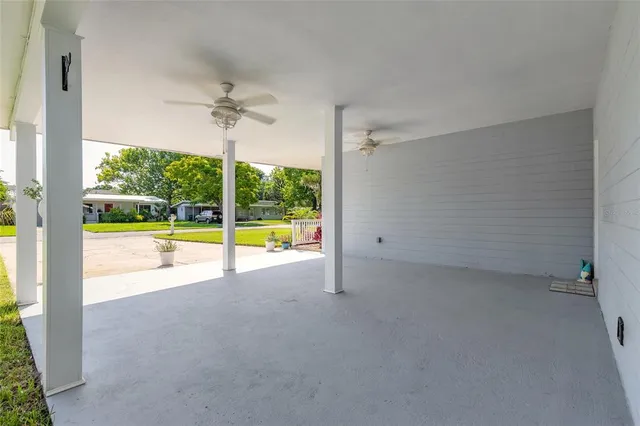 a view of a kitchen with a flat screen tv and a floor to ceiling window