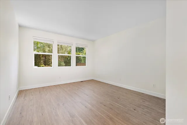 a view of a room with wooden floor