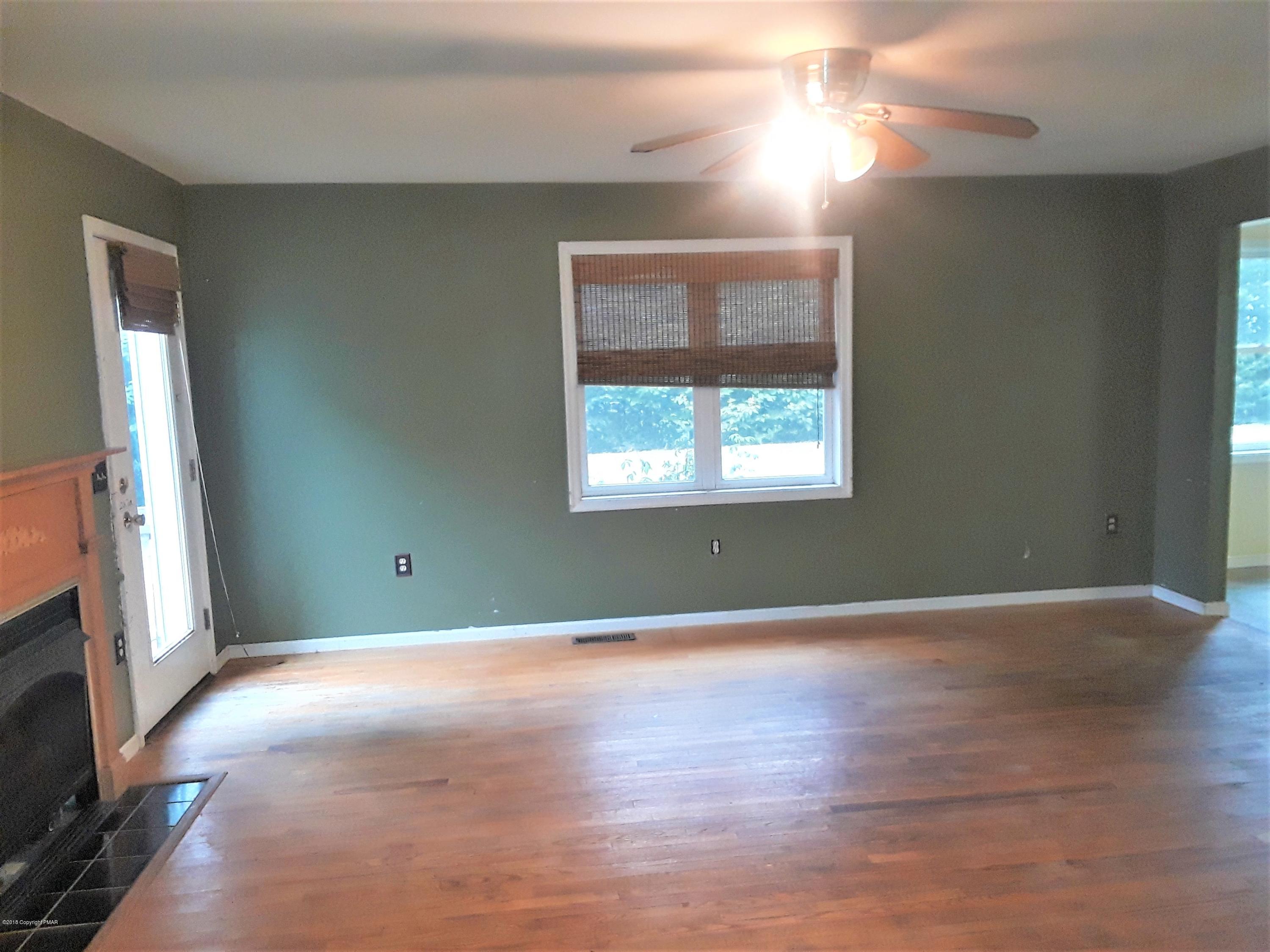 3105 Sequoia Road Tobyhanna, PA 18466 - Photo 13 of 29 a view of an empty room with wooden floor and a window