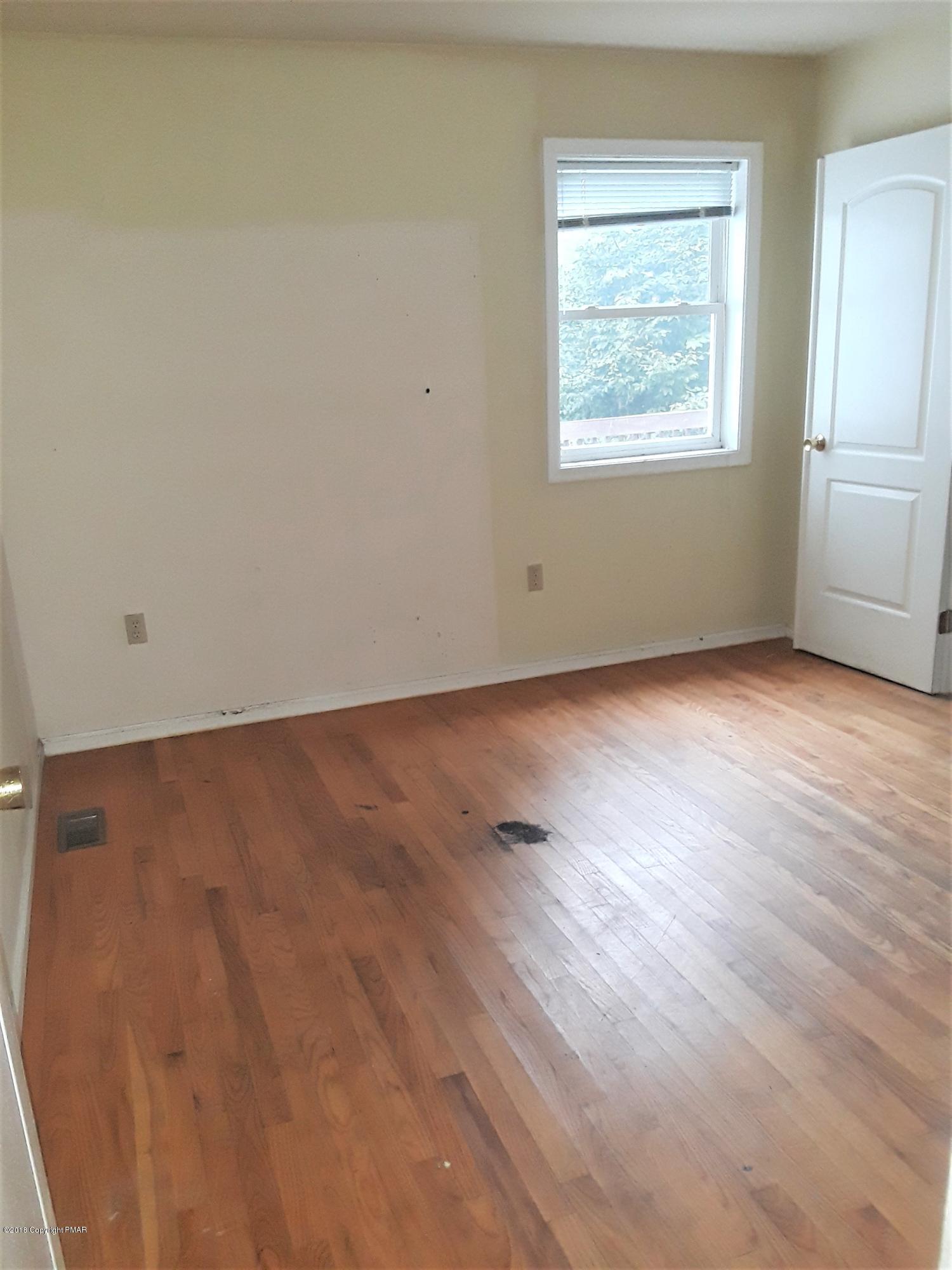 3105 Sequoia Road Tobyhanna, PA 18466 - Photo 15 of 29 an empty room with wooden floor and windows