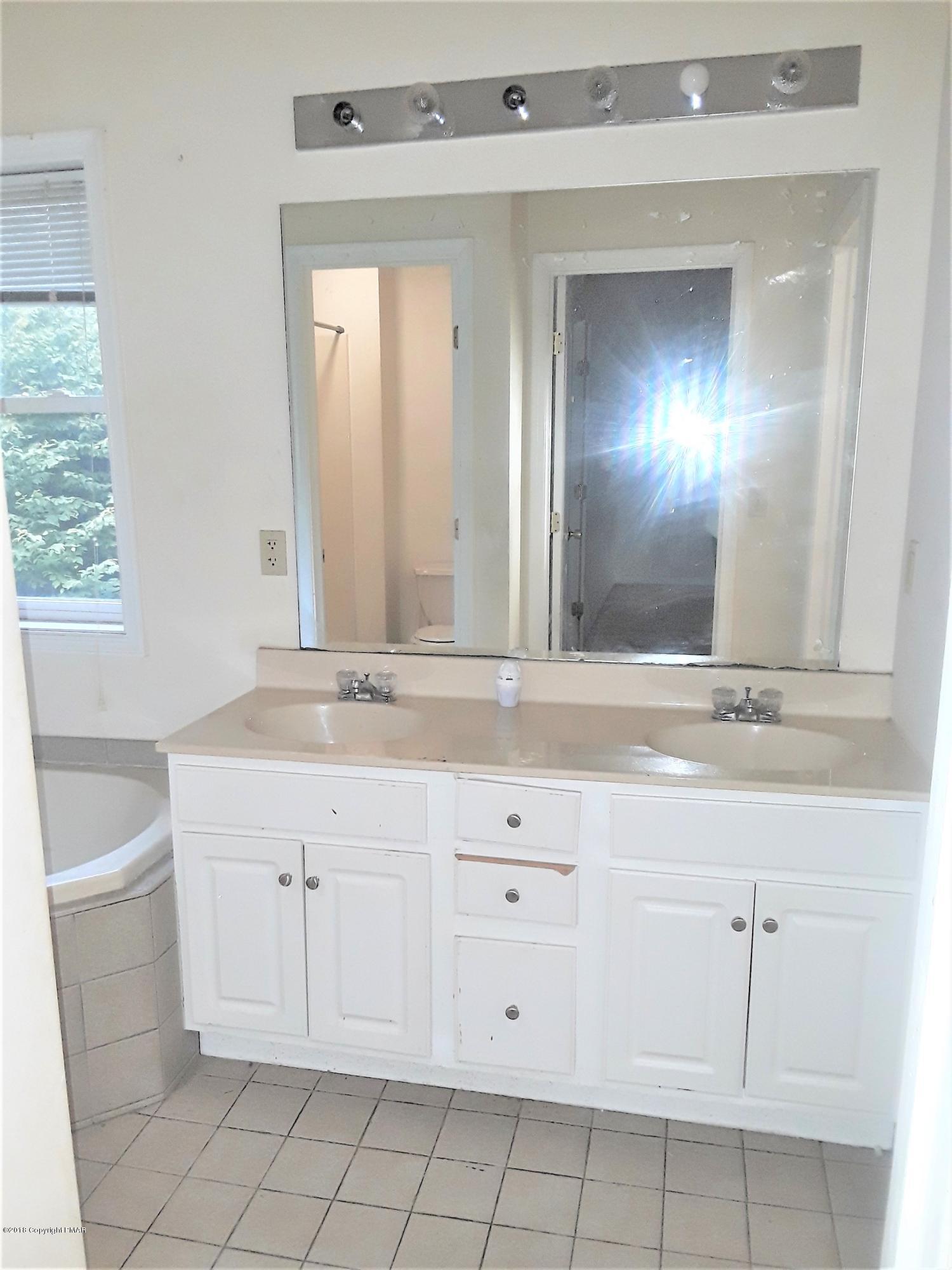 3105 Sequoia Road Tobyhanna, PA 18466 - Photo 16 of 29 a bathroom with a sink and a mirror