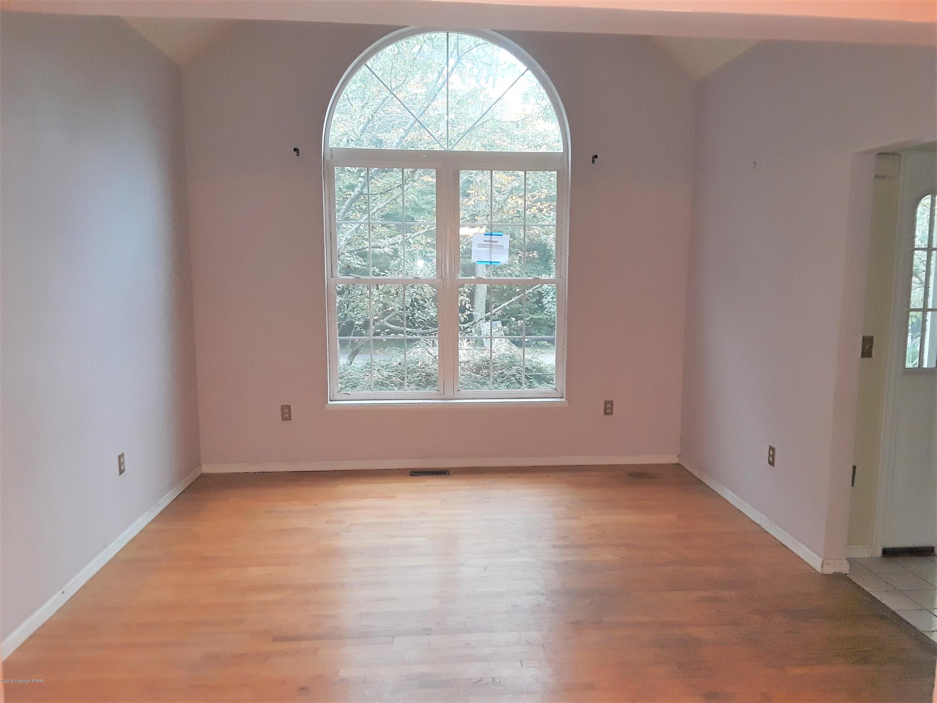 3105 Sequoia Road Tobyhanna, PA 18466 - Photo 7 of 29 an empty room with wooden floor and windows