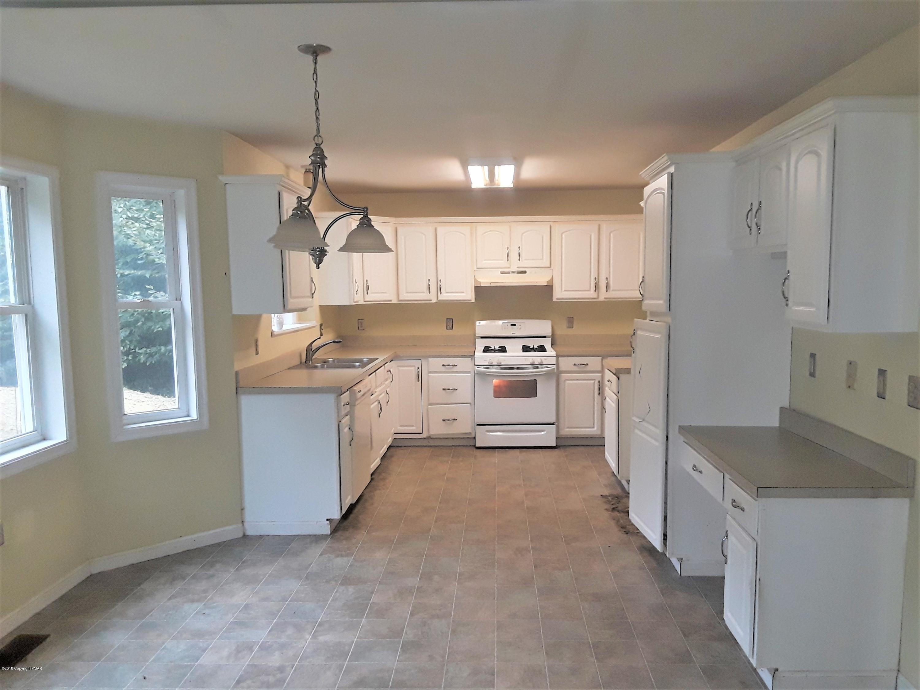 3105 Sequoia Road Tobyhanna, PA 18466 - Photo 10 of 29 a kitchen with stainless steel appliances granite countertop a stove a sink and a refrigerator