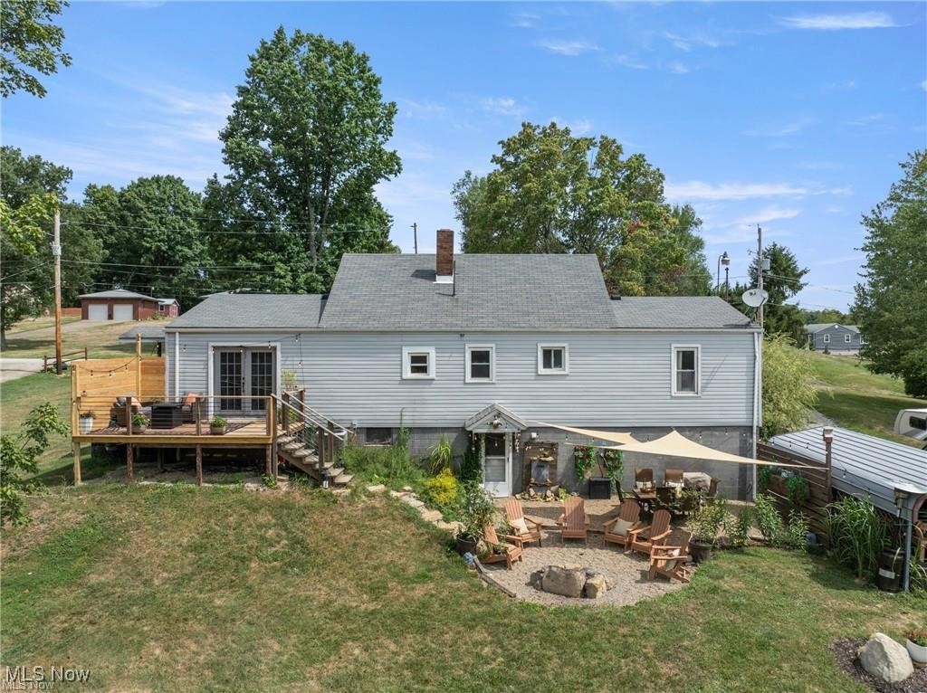 54340 Bracken Road Bridgeport, OH 43912 - Photo 20 of 29 Rear view of house with an outdoor fire pit, a deck, central AC, a patio, and a yard
