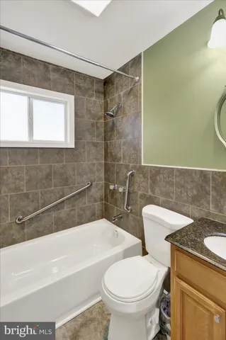 a bathroom with a toilet a sink and bathtub
