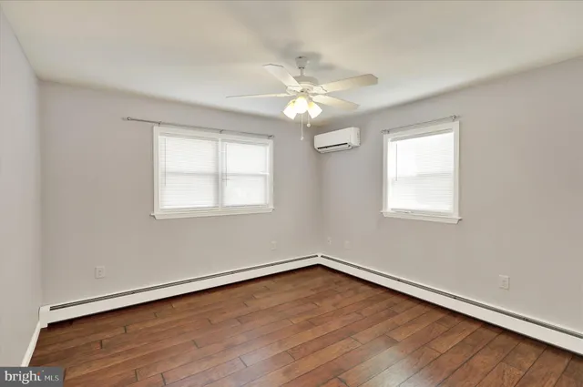 a view of a room with wooden floor and a window
