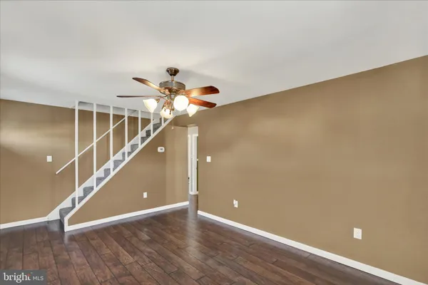 a view of a room with wooden floor