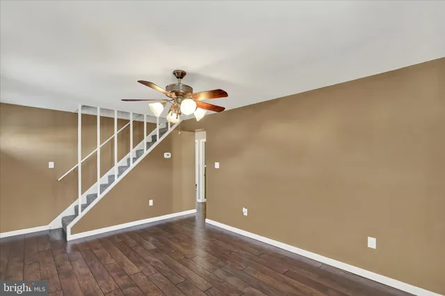 a view of a room with wooden floor