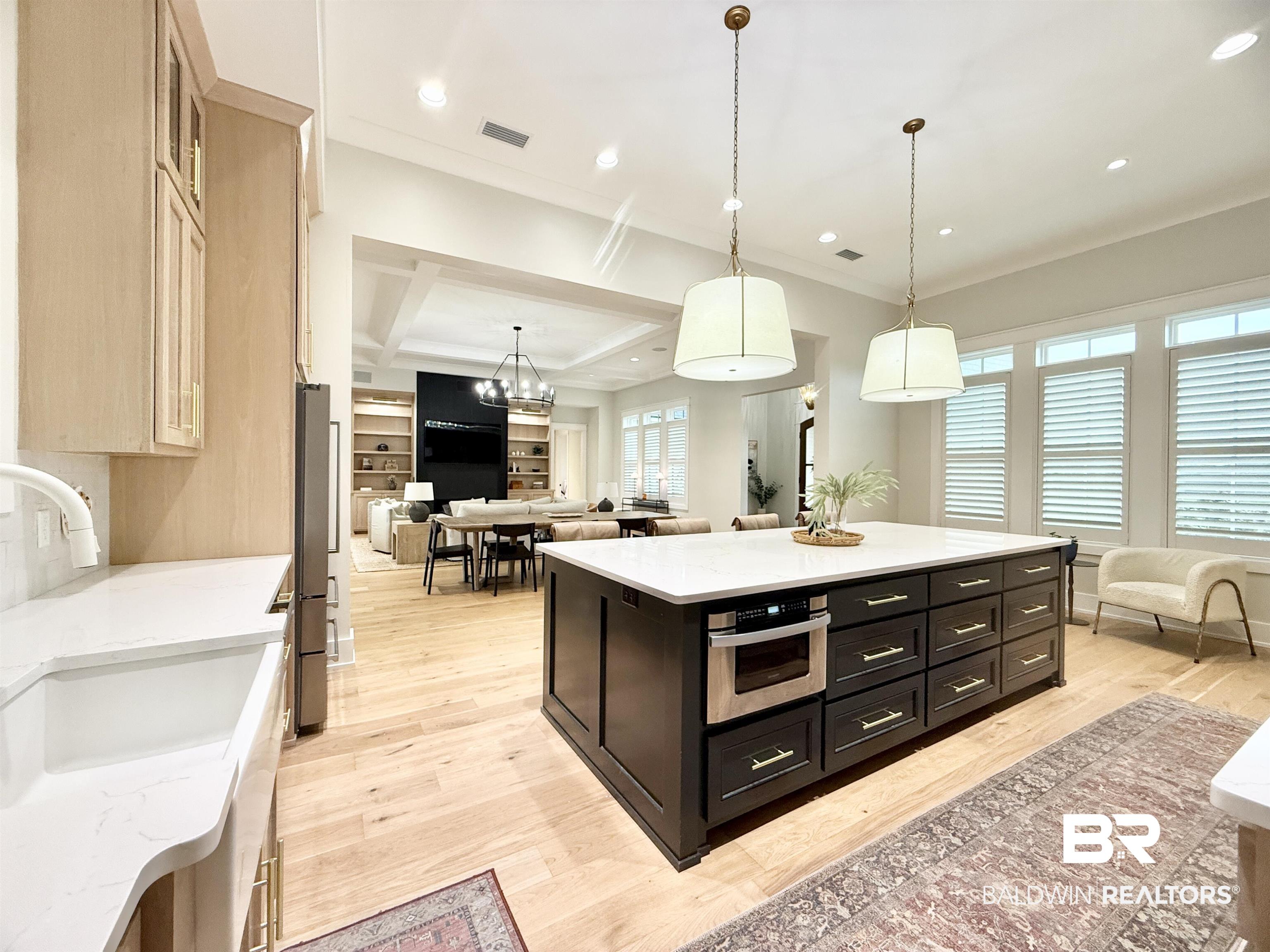 21767 Gallery Boulevard Fairhope, AL 36532 - Photo 74 of 74 Kitchen featuring open floor plan, light wood-style flooring, ornamental molding, stainless steel appliances, and decorative light fixtures