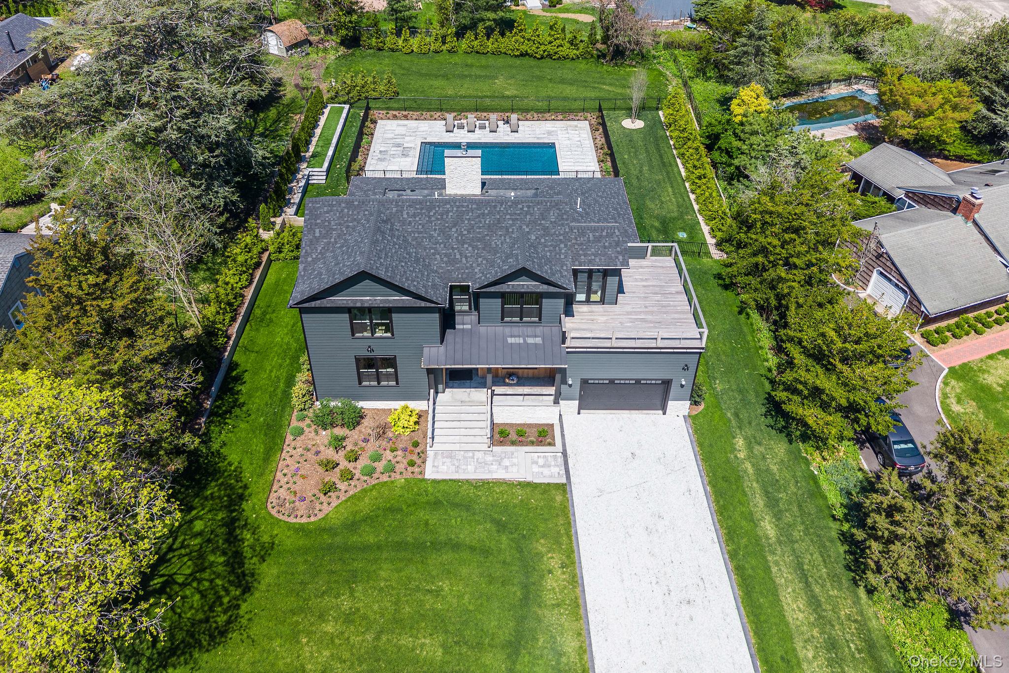 1665 Glenn Road Southold, NY 11971 - Photo 2 of 46 an aerial view of a house with a garden
