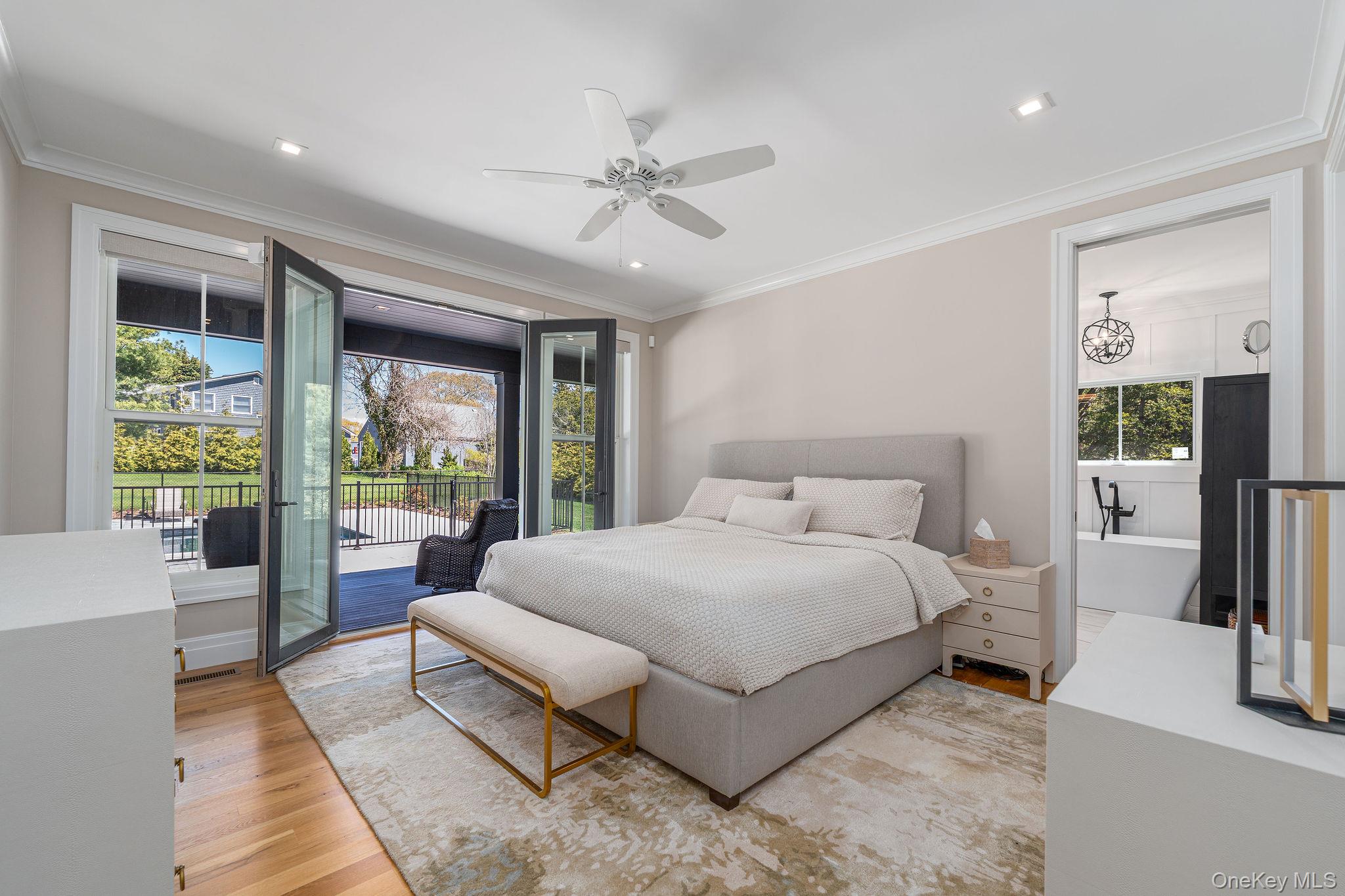 1665 Glenn Road Southold, NY 11971 - Photo 21 of 46 a spacious bedroom with a large bed and a large window