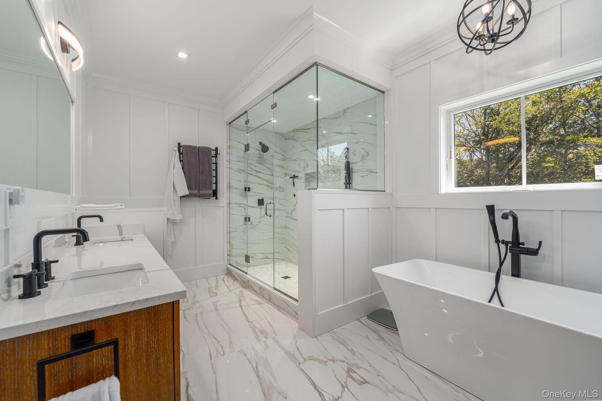 1665 Glenn Road Southold, NY 11971 - Photo 22 of 46 a bathroom with a tub a sink and a large mirror