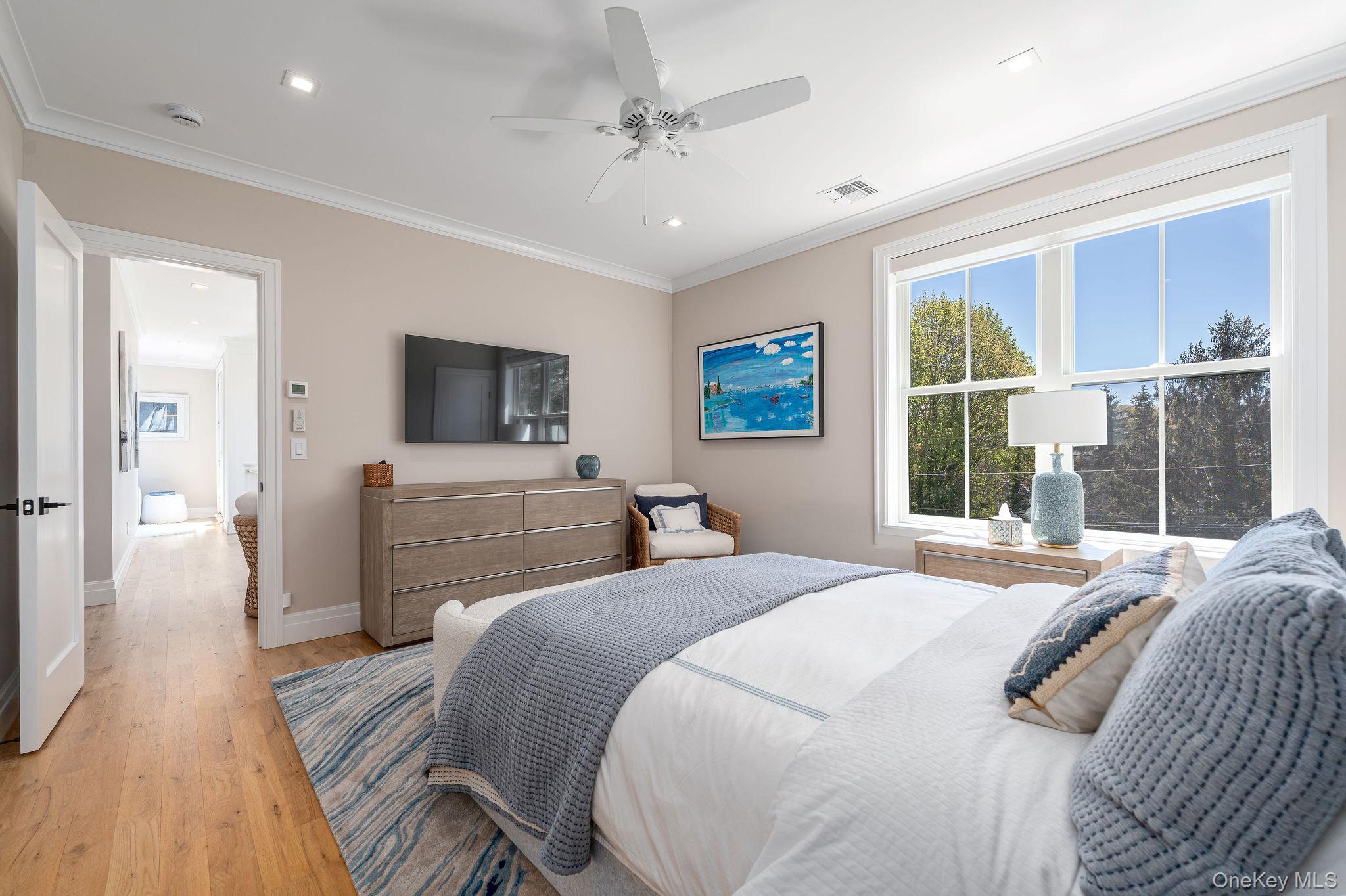 1665 Glenn Road Southold, NY 11971 - Photo 24 of 46 a bedroom with a bed and a chandelier