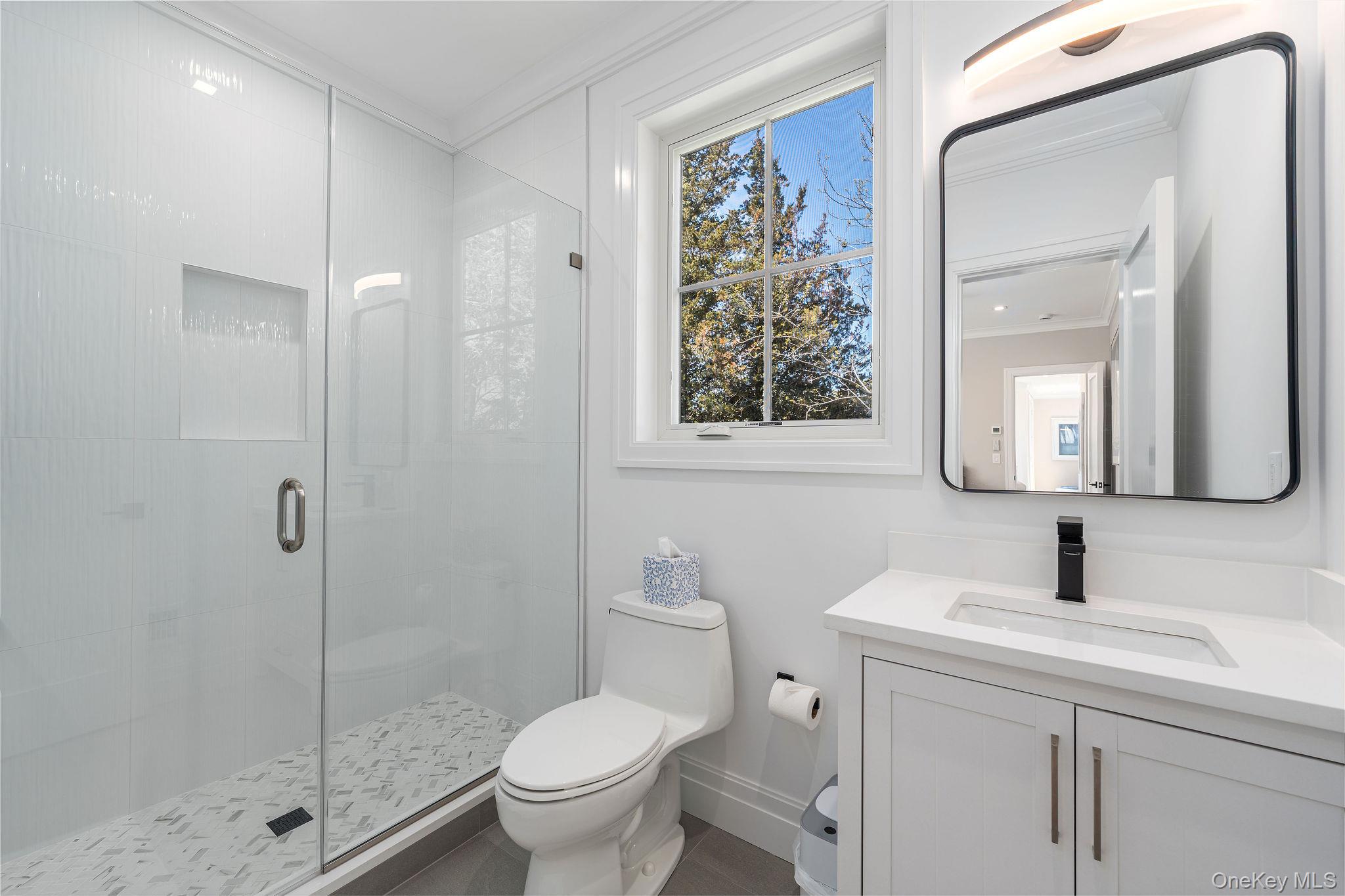1665 Glenn Road Southold, NY 11971 - Photo 25 of 46 a bathroom with a toilet sink and shower