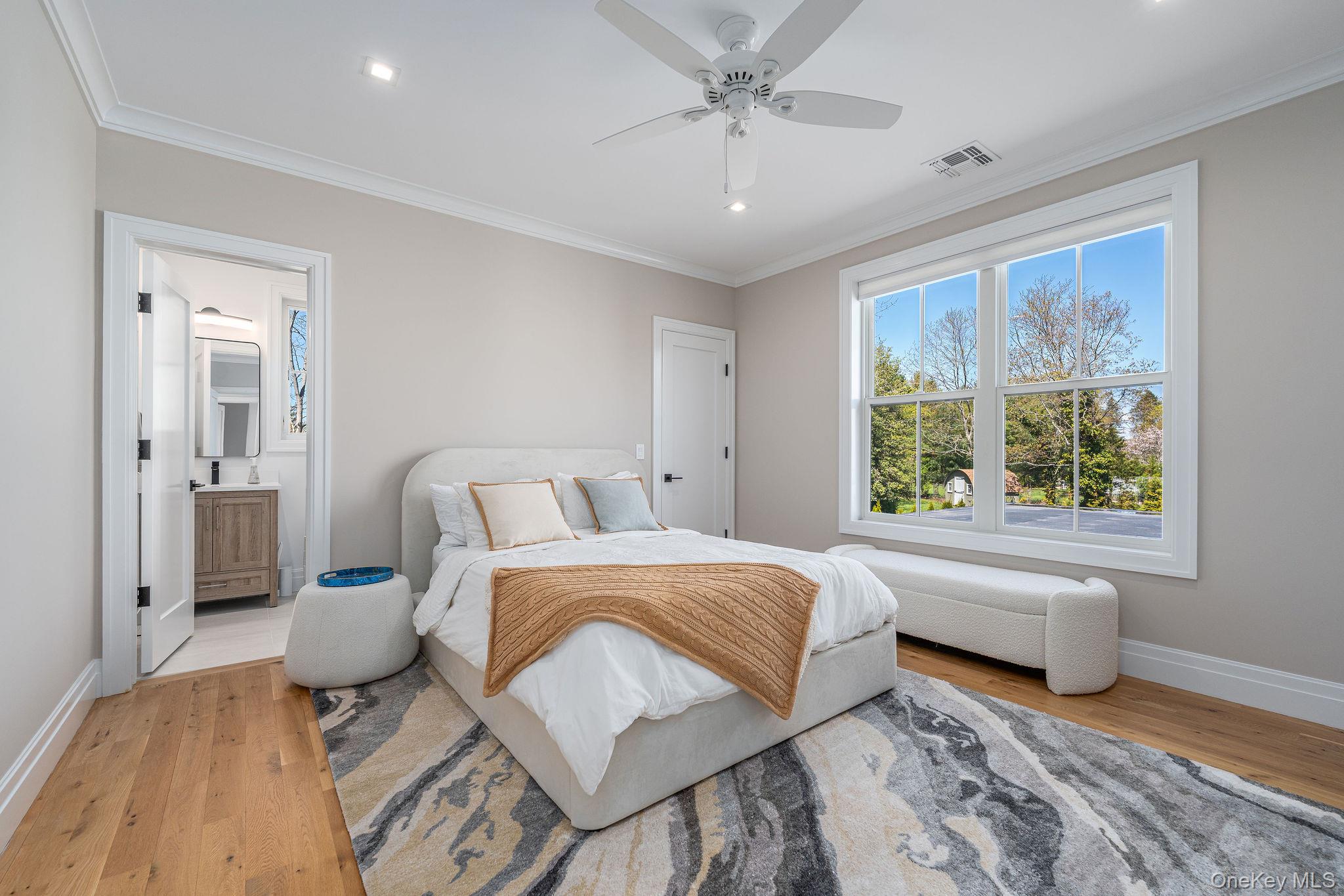 1665 Glenn Road Southold, NY 11971 - Photo 26 of 46 a spacious bedroom with a bed and wooden floor