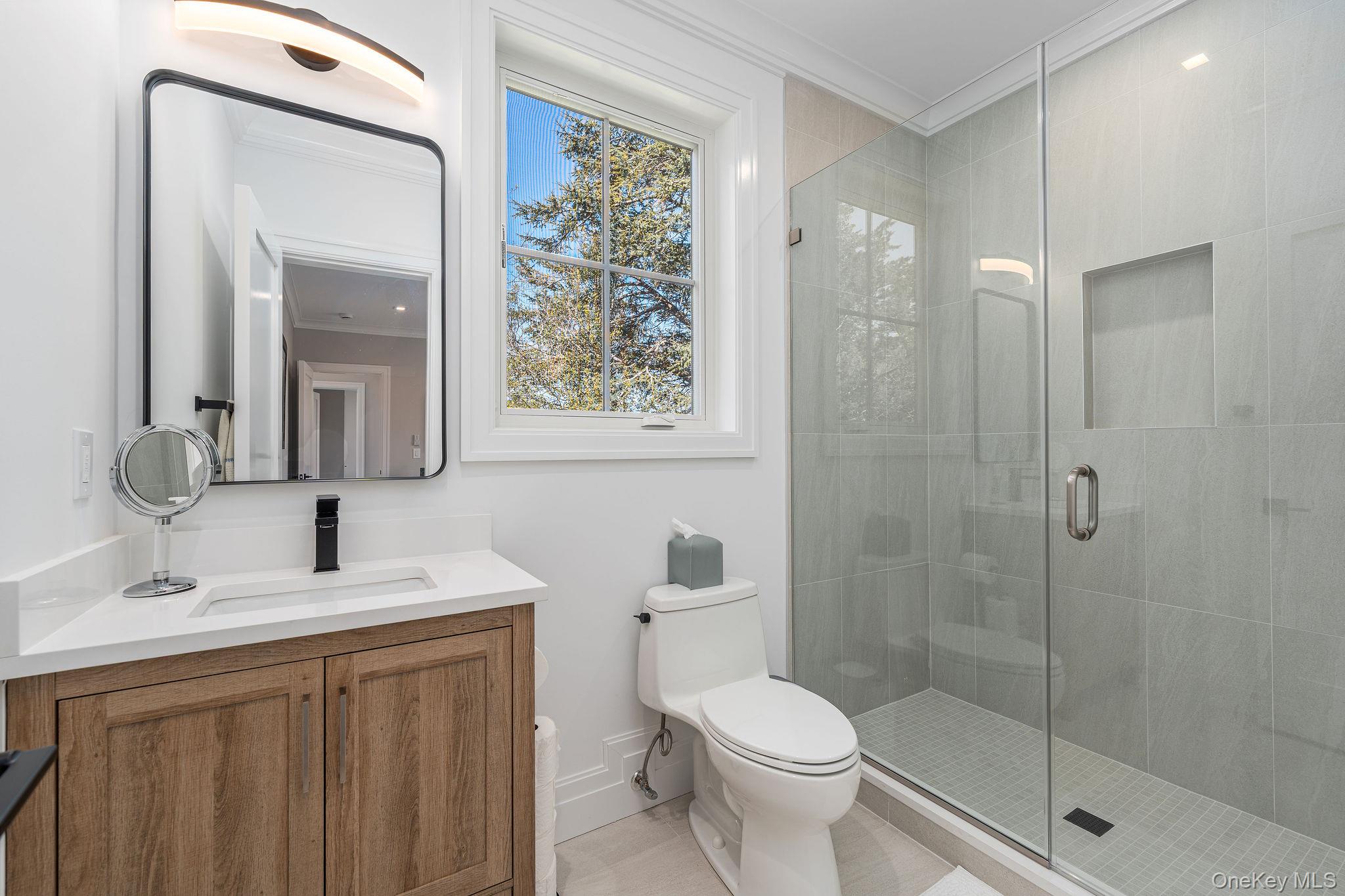 1665 Glenn Road Southold, NY 11971 - Photo 27 of 46 a bathroom with a sink a toilet and shower