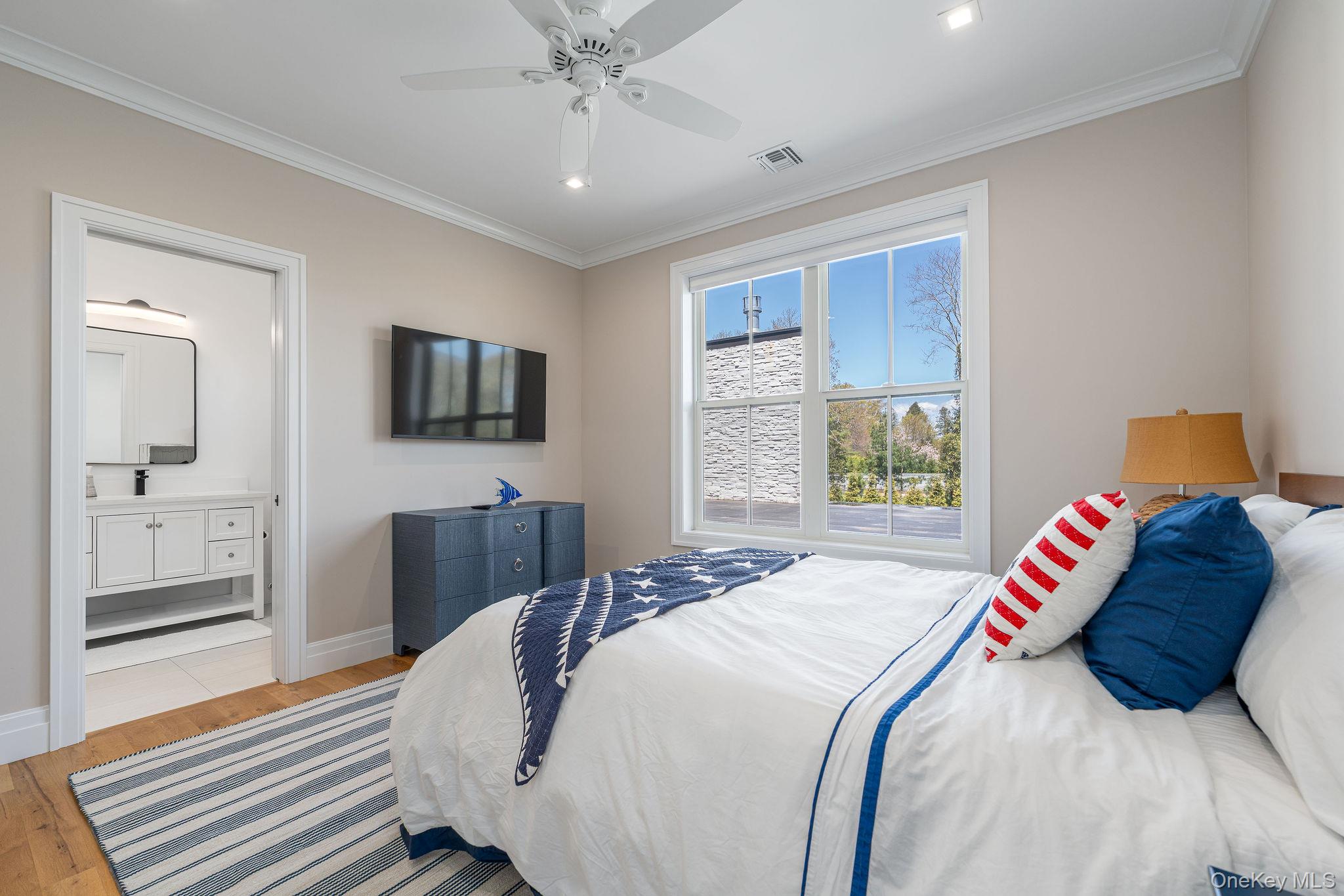 1665 Glenn Road Southold, NY 11971 - Photo 28 of 46 a bedroom with a bed and wooden floor