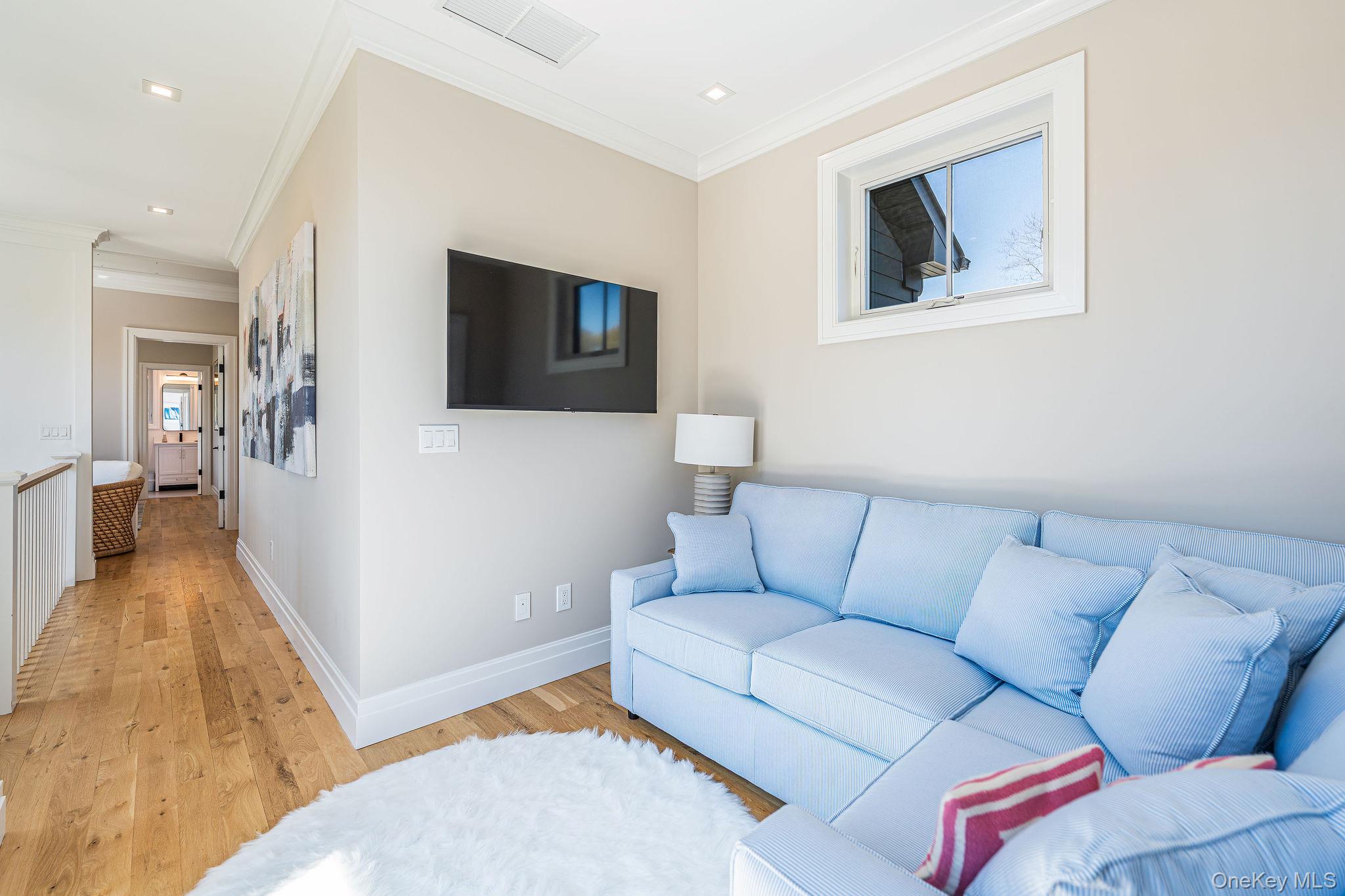 1665 Glenn Road Southold, NY 11971 - Photo 33 of 46 a living room with furniture and a flat screen tv