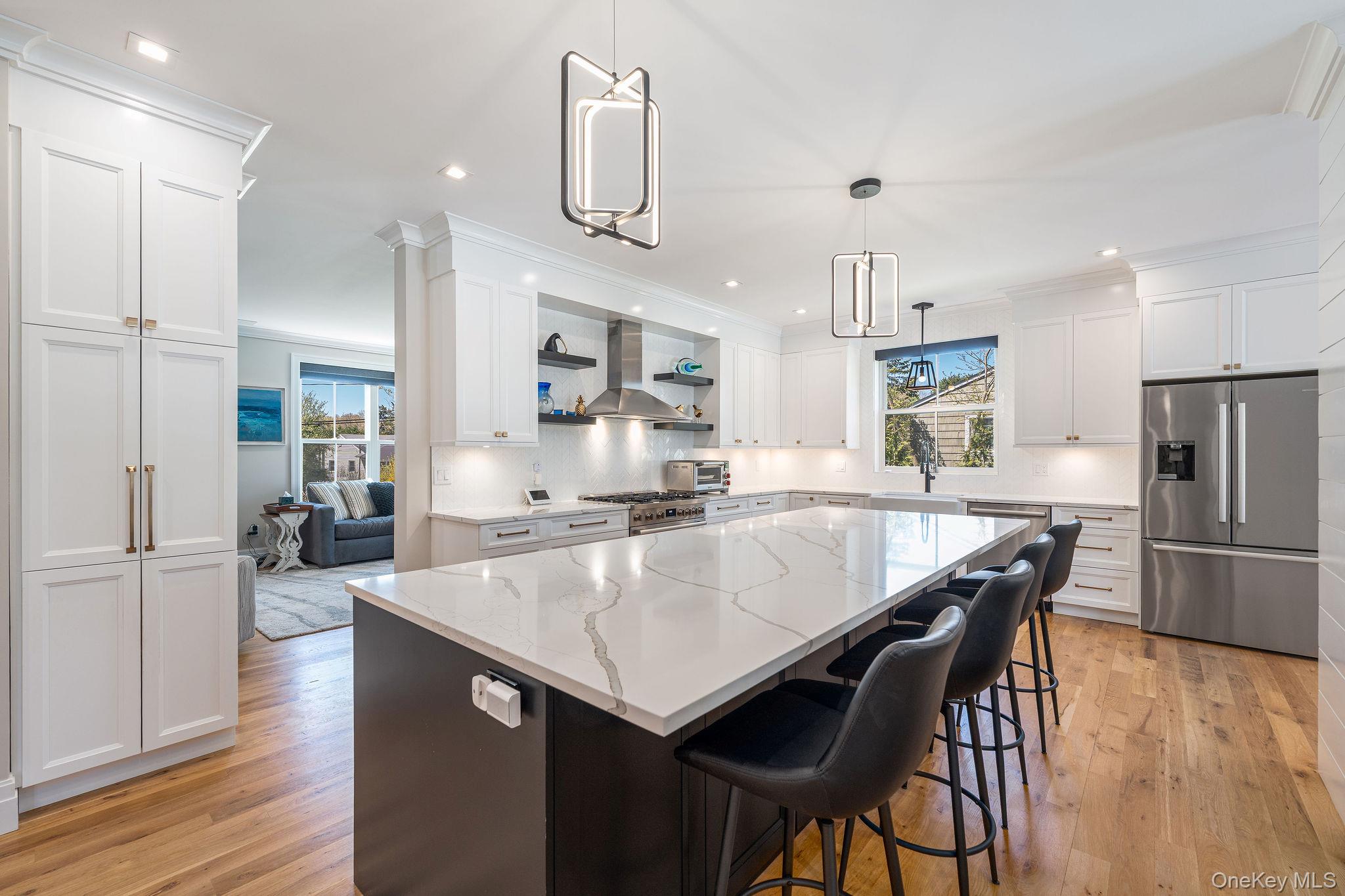 1665 Glenn Road Southold, NY 11971 - Photo 7 of 46 a large kitchen with kitchen island a large counter top space and stainless steel appliances