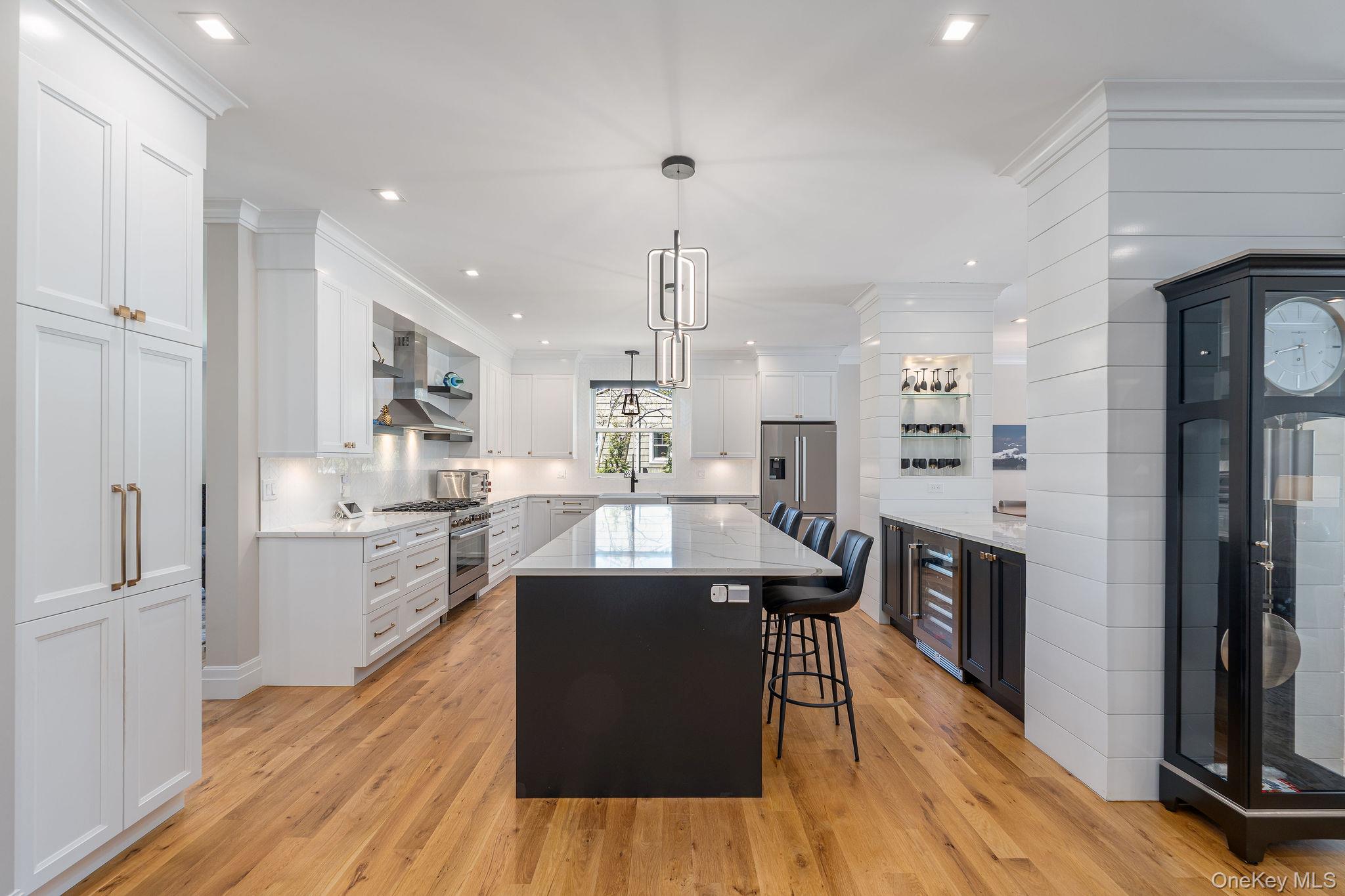 1665 Glenn Road Southold, NY 11971 - Photo 10 of 46 a kitchen with stainless steel appliances granite countertop a sink stove and wooden floor