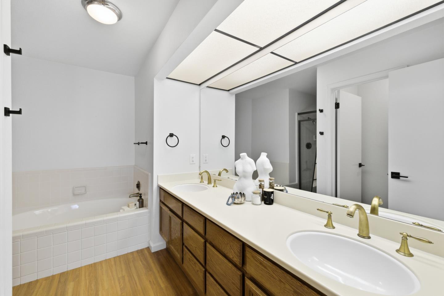 1669 Geary Road Walnut Creek, CA 94597 - Photo 32 of 39 a bathroom with a tub sink and mirror