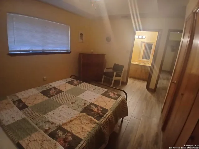 a bedroom with a bed and a chair in it