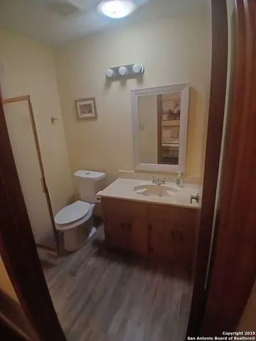 a bathroom with a sink a toilet and mirror