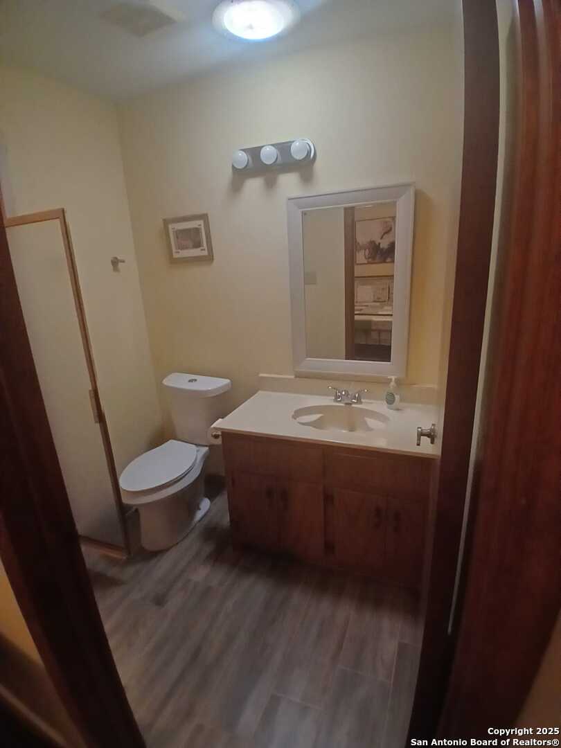 1816 Polk Street Mission, TX 78572 - Photo 14 of 21 a bathroom with a sink a toilet and mirror