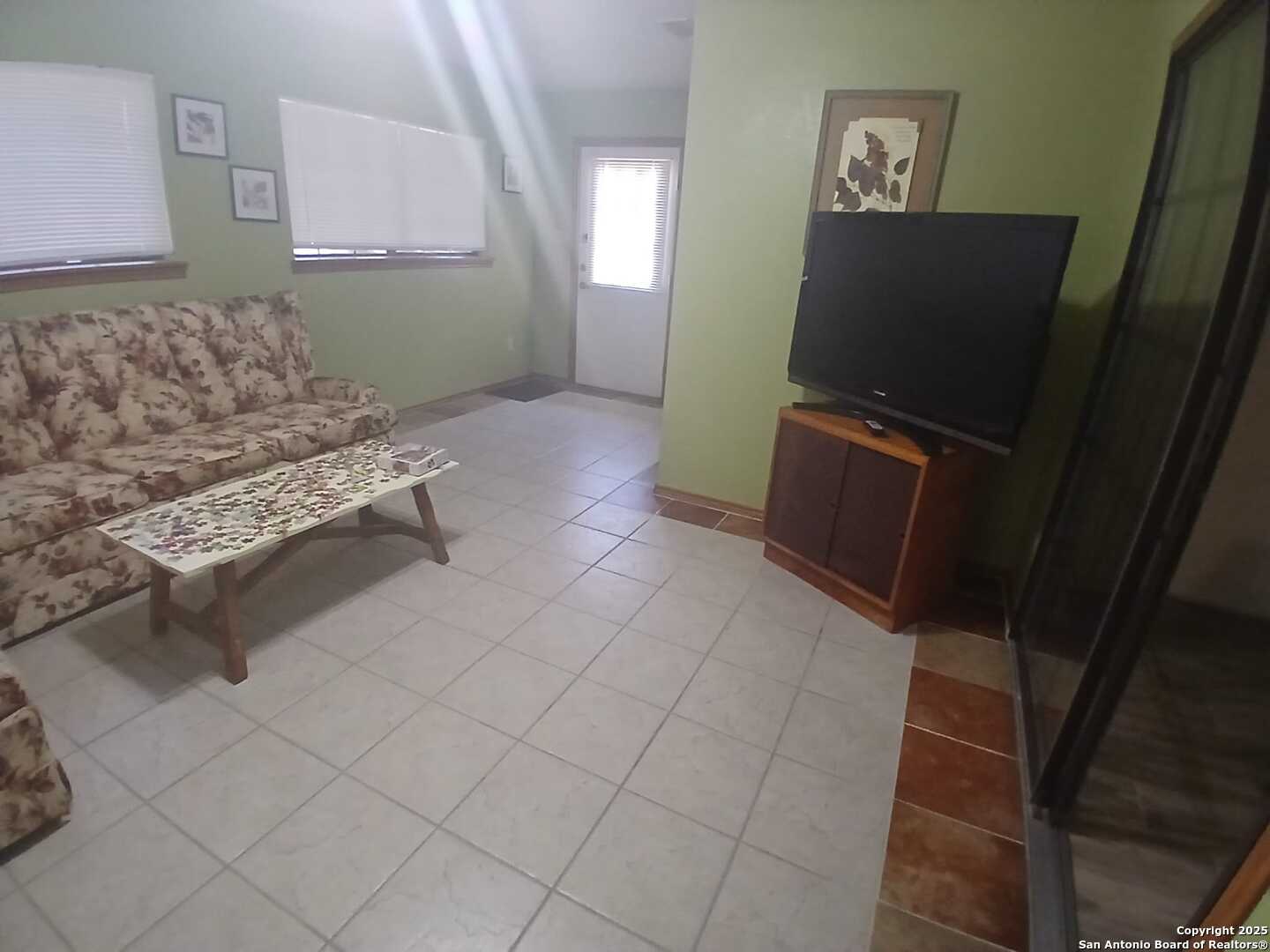 1816 Polk Street Mission, TX 78572 - Photo 16 of 21 a living room with furniture and a flat screen tv