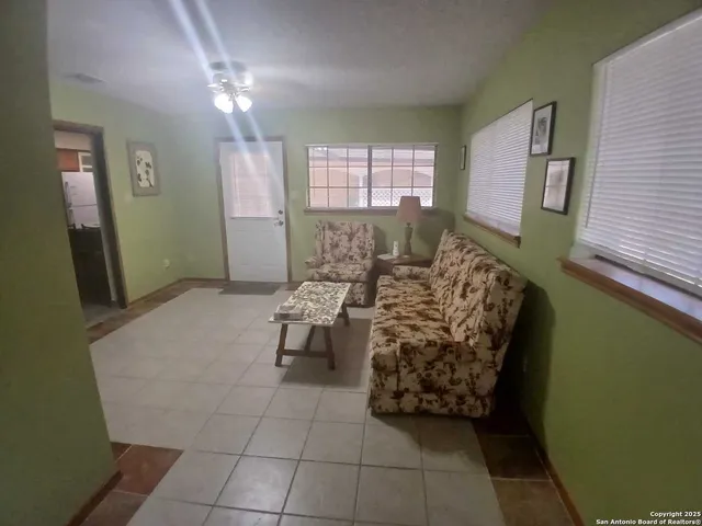 a living room with furniture and a large window