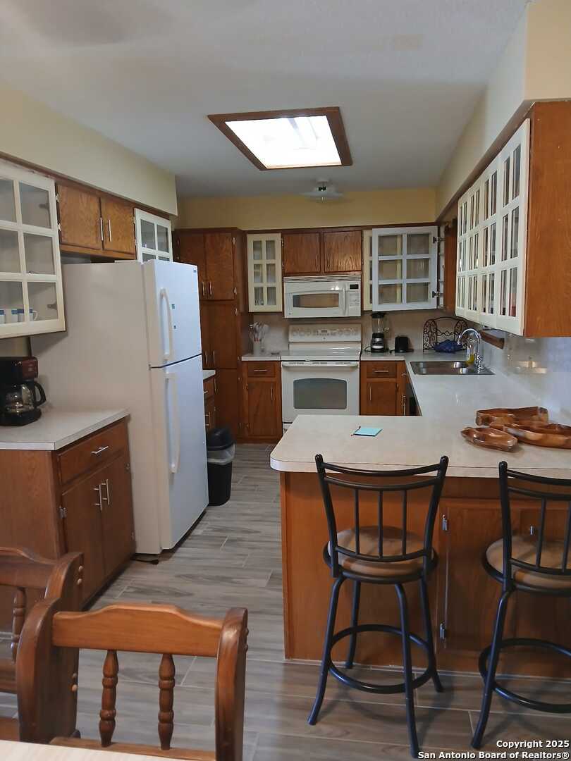 1816 Polk Street Mission, TX 78572 - Photo 7 of 21 a kitchen with a table chairs refrigerator and microwave
