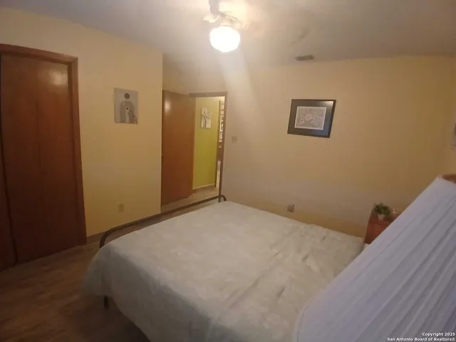 a bedroom with a bed and a mirror