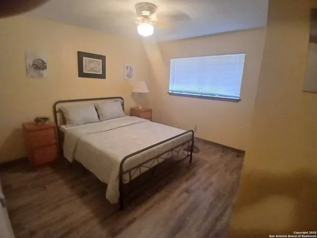 a bedroom with a bed and a night stand