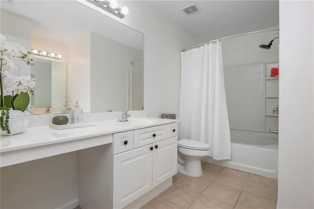 a bathroom with a double vanity sink toilet and shower
