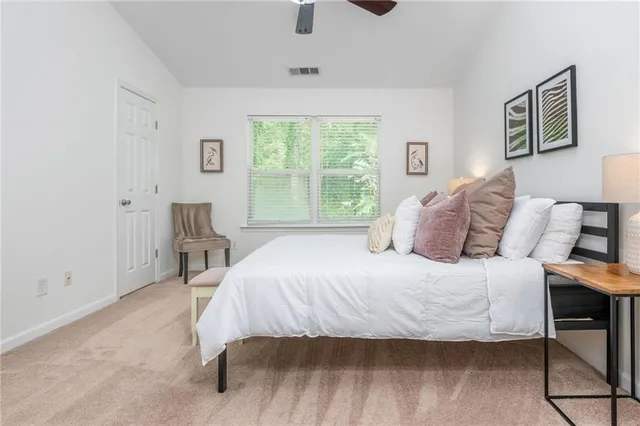 a bedroom with a bed and a table