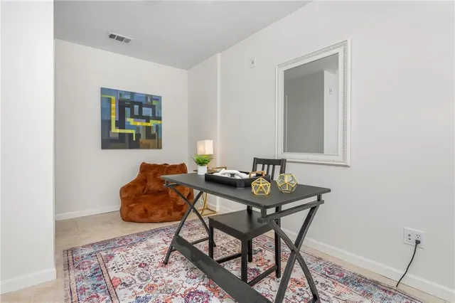 a view of a workspace room with furniture and wooden floor