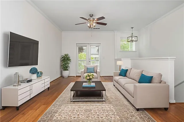 a living room with furniture ceiling fan and a window
