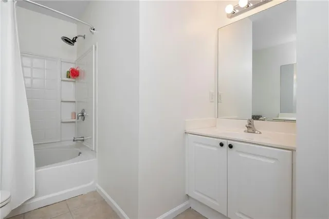 a bathroom with a bathtub sink and mirror