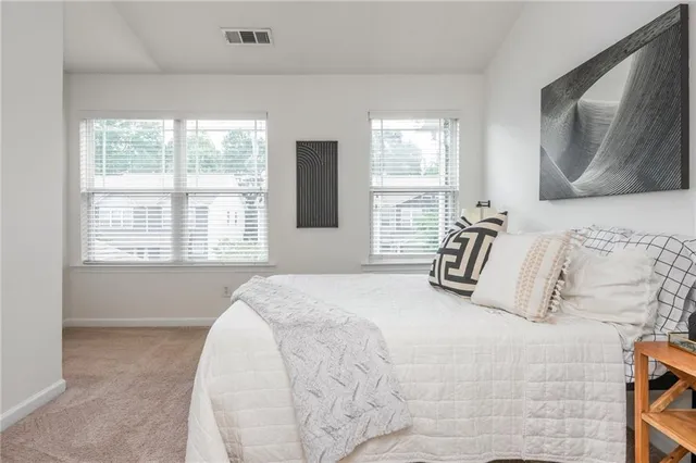a bedroom with a large bed and a large window