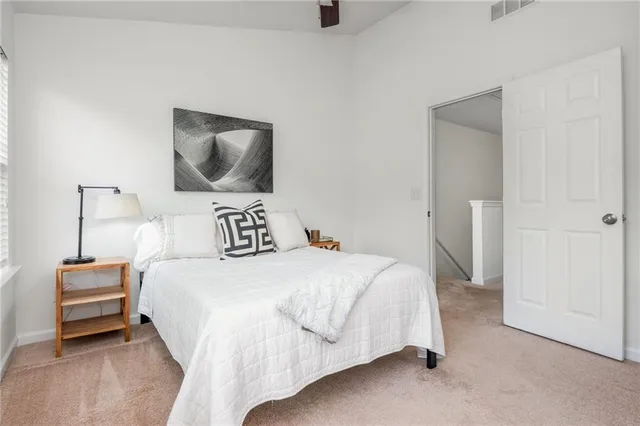 a bedroom with a bed and a lamp