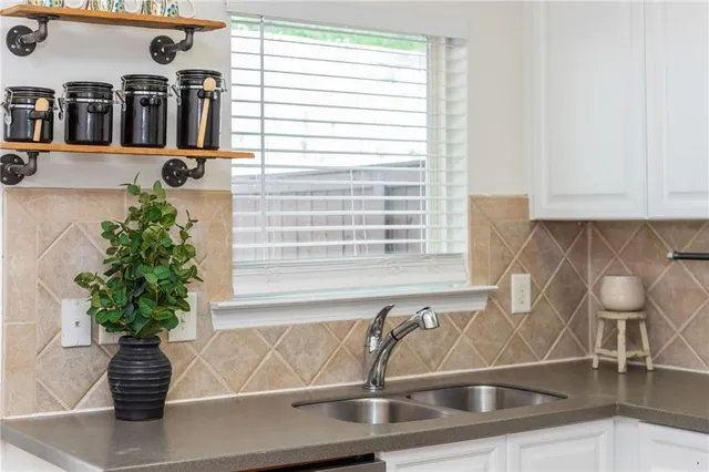 a vase of flowers sitting on a table with a fireplace